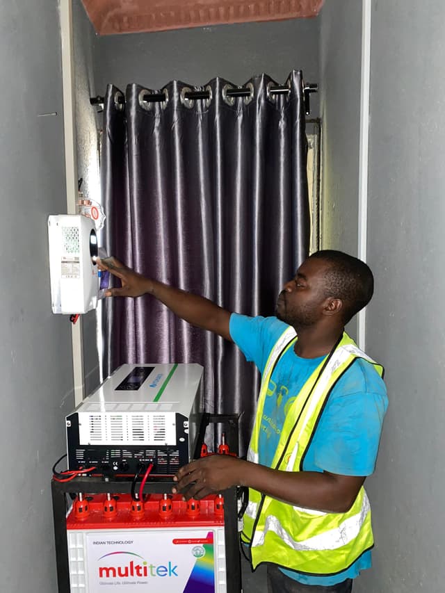 Electrician installing inverter